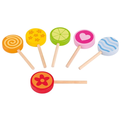 Set of colorful wooden lollipops on sticks against a white background