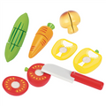 Set of toy kitchen vegetables and utensils on a white background