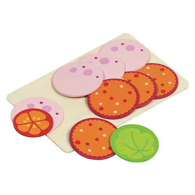 Colorful toy pizza with various toppings on a white background