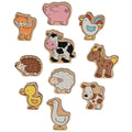 Set of wooden farm animal toys on a white background