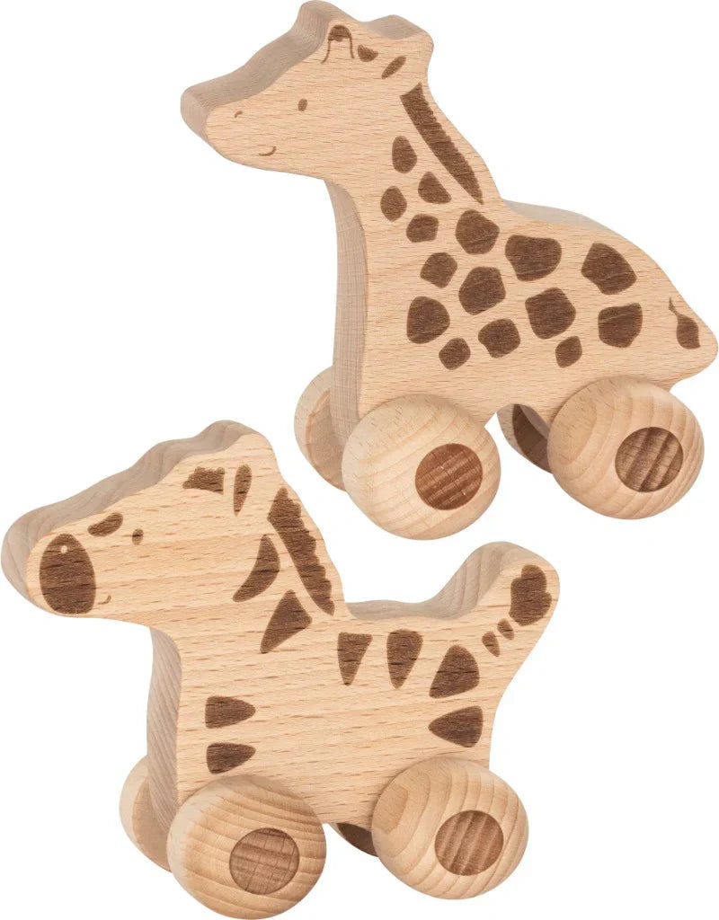 Two wooden giraffe toys on wheels against a white background