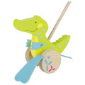 Toy alligator with a wooden base on a white background
