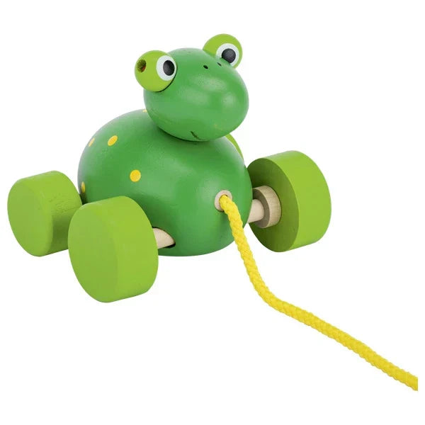 Green toy frog with a yellow pull string on a white background