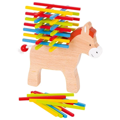 Wooden piggy bank with colorful sticks on a white background