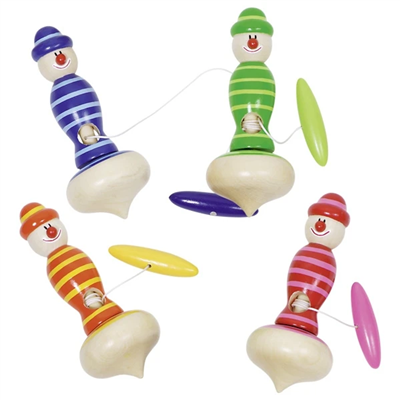 Set of colorful wooden spinning tops with clown faces on a white background
