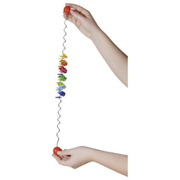 Colorful cat toy with a string held by two hands on a white background