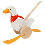 Wooden toy goose with a red bandana on a white background
