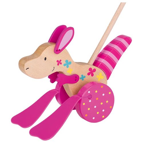 Wooden toy rabbit with pink outfit on a white background