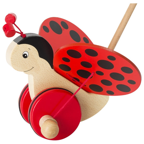 Wooden ladybug pull toy with red and black design on a white background
