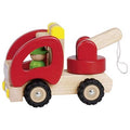 Wooden toy truck with a pull handle and small figure inside on a white background