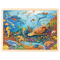 Wooden puzzle with an underwater scene featuring dolphins, turtles, and various sea creatures.