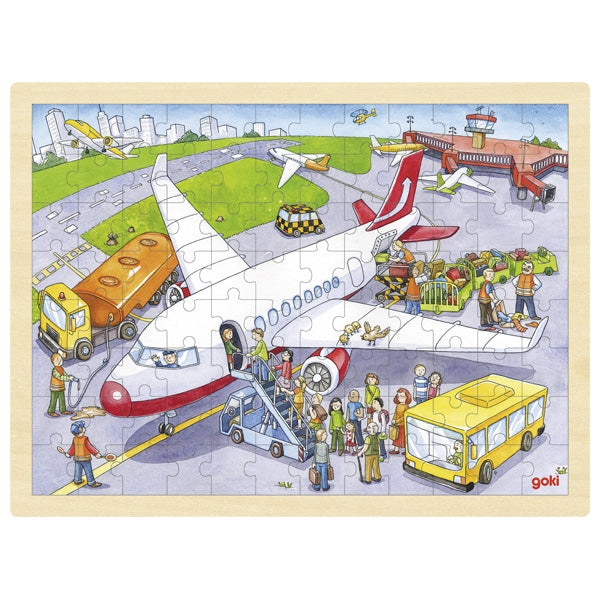Children's puzzle with an airport scene featuring airplanes and people, made by Goldi.