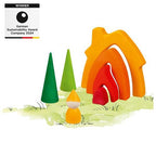 Colorful wooden toy house with trees and a gnome on a white background, featuring an award badge.