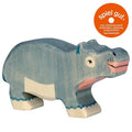 Wooden hippo toy with 'spiel gut' certification label on a white background