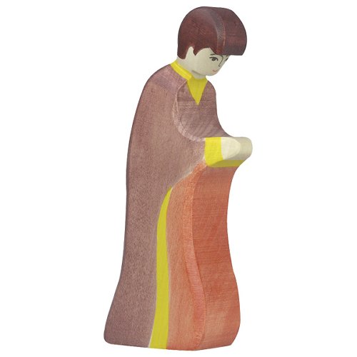 Wooden figurine of a person wearing a long, patterned dress on a white background