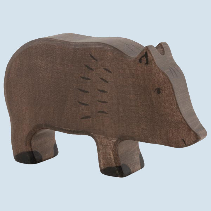 Wooden boar figurine on a light blue background