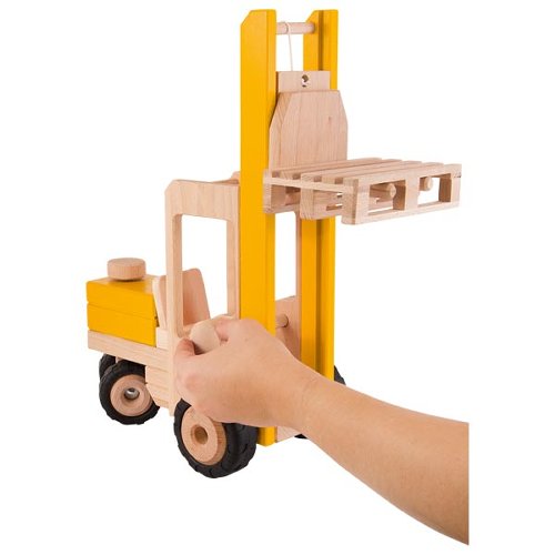 Wooden toy forklift with a hand holding it on a white background
